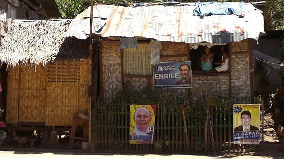 Political banners and stickers of candidates hang in a hut in the Philippines as the country embarks