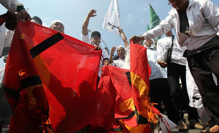 Aksi FPI membakar kain berlambang PKI. (Antara)