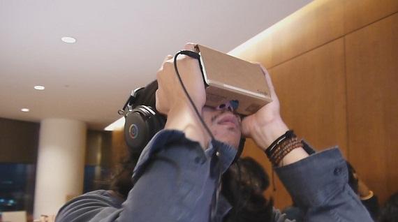 A journalist in Tokyo tests out Google Cardboard, which creates virtual reality by attaching to a us