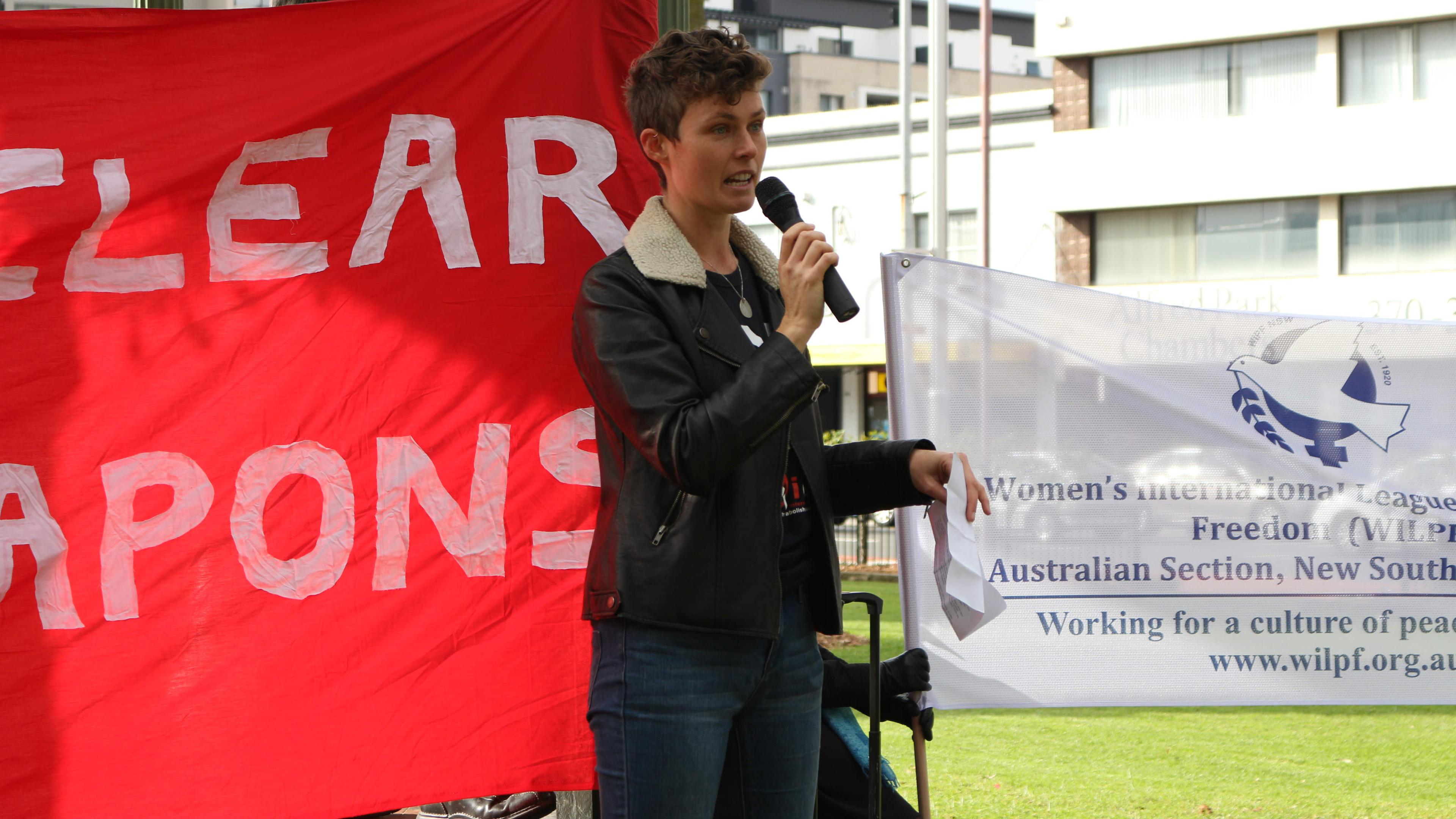 Activist Gemma Romuld addresses a crowd in Sydney, protesting Australia's boycott of treaty negotiat