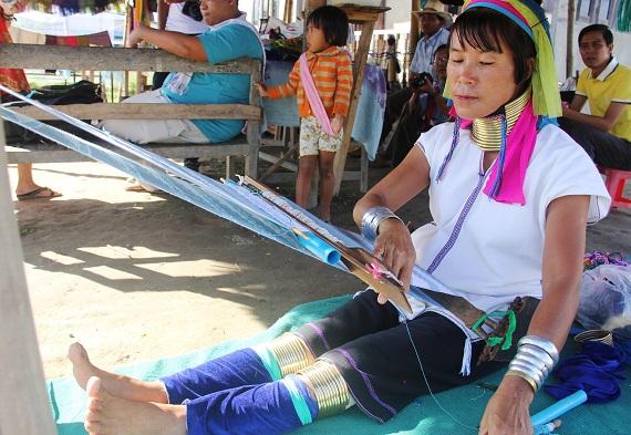Kayan women is sewing traditional dresses to sell visitors. (Photo: Phyu Zin Poe)