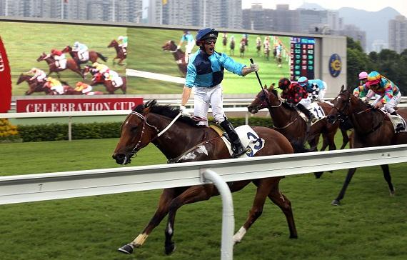 Jockey Neil Callan celebrates winning one of the biggest races of the Hong Kong racing calendar, the