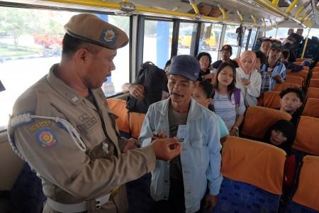 Anggota Satpol PP Kabupaten Badung memeriksa identitas pemudik yang akan balik Lebaran di Terminal M