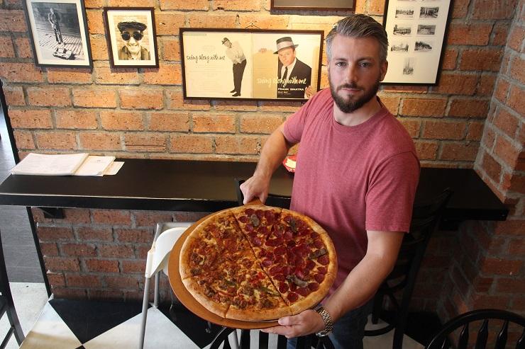 Mike Helfman with a pizza (Photo: David Grunebaum)