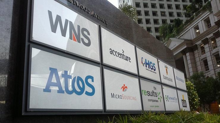 The names of mostly multinational IT-BPO companies are seen at the entrance of a building at Eastwoo