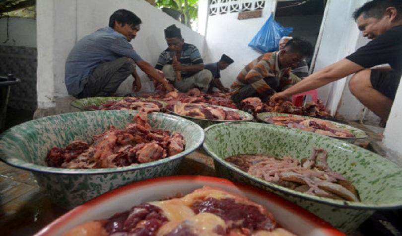 Wabah PMK, Jamaah Tarekat Naqsabandiyah membersihkan daging kurban yang akan dibagikan di  Padang, S